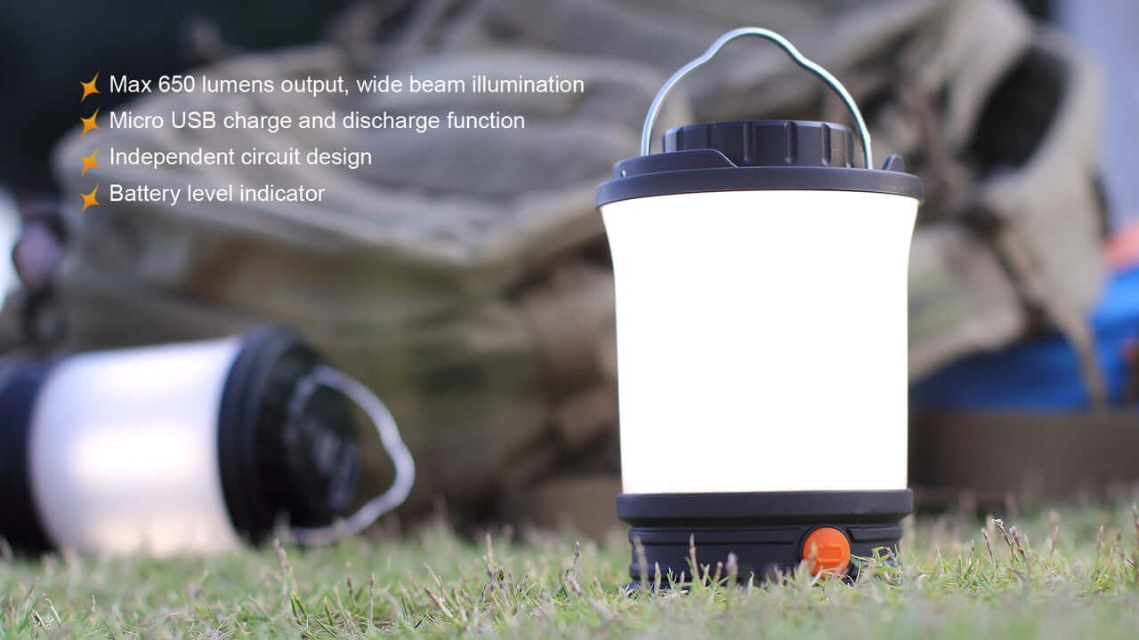 Fenix CL30R camping lantern with 650 lumens, Micro-USB recharge, and battery level indicator on grass.