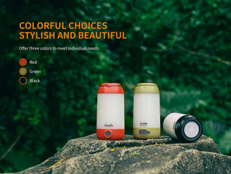 Fenix CL26R camping lanterns in red, green, and black showcased outdoors, highlighting stylish and practical color options.