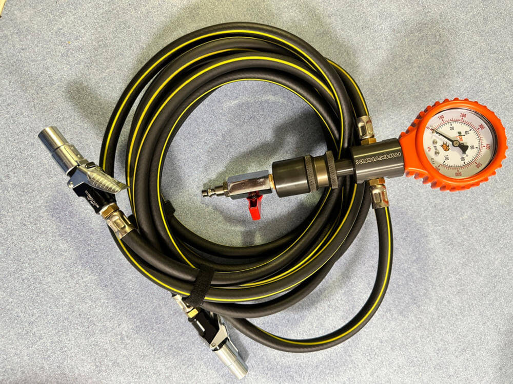 Locking air chuck with hose and pressure gauge for hands-free tire inflation and pressure measurement.